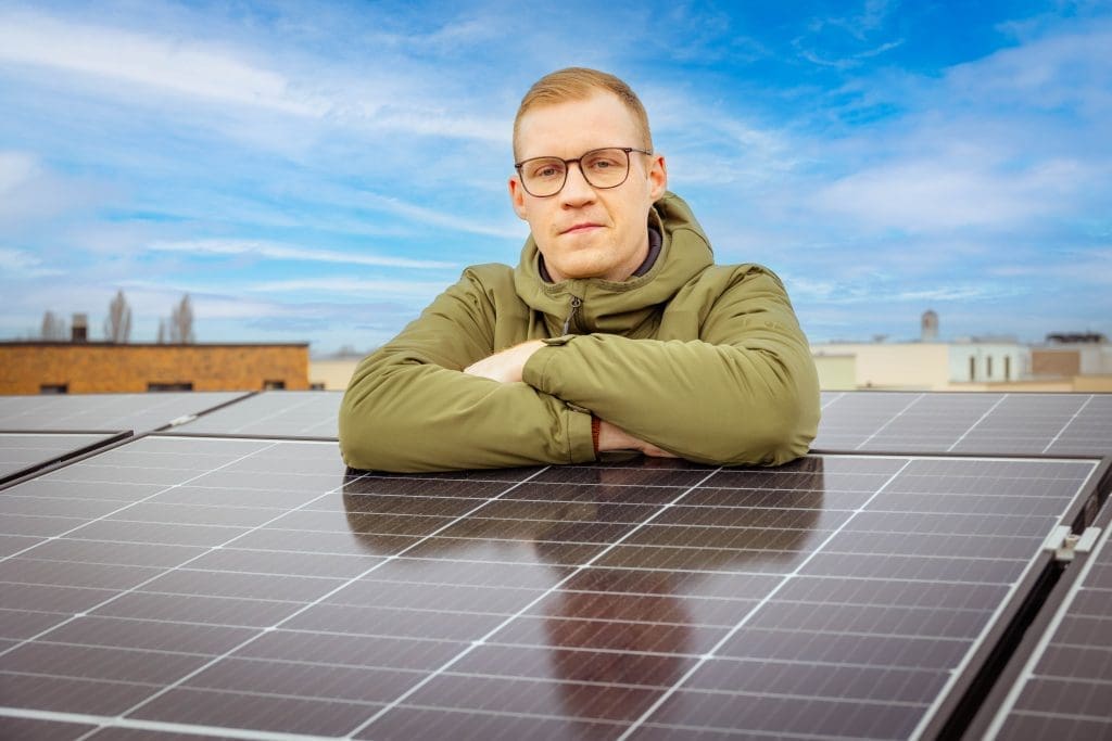 Bild: © WIEDERAUFBAU Mann lehnt sich auf Photovoltaik-Anlage