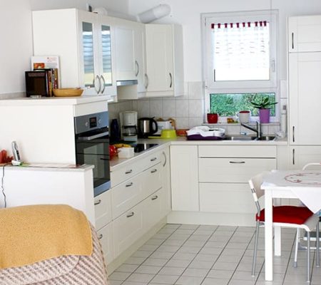 Bild: © WIEDERAUFBAU Beispiel einer Wohnküche mit hellen Bodenfliesen und Fenster im Betreuten Wohnen Cremlingen.